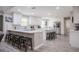 Bright kitchen features white cabinets, stainless steel appliances, and a spacious island with seating at 1416 Leighton Ave, Lakeland, FL 33803