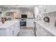 Kitchen with an island featuring white cabinets, stainless steel appliances, and modern countertops at 1416 Leighton Ave, Lakeland, FL 33803