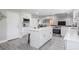 Kitchen with an island featuring white cabinets, stainless steel appliances, and modern countertops at 1416 Leighton Ave, Lakeland, FL 33803