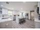 Bright kitchen features white cabinets, stainless steel appliances, and a spacious island with seating at 1416 Leighton Ave, Lakeland, FL 33803