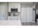 Kitchen with white cabinets, stainless steel microwave and a bi-fold pantry at 1416 Leighton Ave, Lakeland, FL 33803