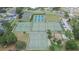 Aerial view showcasing community tennis and pickleball courts, plus a playground and parking area at 1716 Bayou Cir, Lakeland, FL 33803