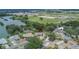 Aerial view of home showing a spacious lot, nearby lake, and proximity to amenities and attractions at 1716 Bayou Cir, Lakeland, FL 33803