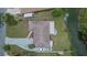Aerial view of the property featuring a spacious lot, long driveway, and access to a waterfront canal at 1716 Bayou Cir, Lakeland, FL 33803