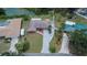 Aerial view highlighting the home's location with a spacious lot, long driveway, and waterfront canal access at 1716 Bayou Cir, Lakeland, FL 33803