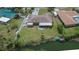 Aerial view of a charming home with a spacious yard, lush landscaping, and waterfront access at 1716 Bayou Cir, Lakeland, FL 33803