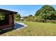 Serene backyard featuring a lakeside view with lush greenery and access to a private dock at 1716 Bayou Cir, Lakeland, FL 33803