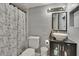 Bathroom showcasing a toilet, vanity with an above-counter sink, and shower with patterned curtain at 1716 Bayou Cir, Lakeland, FL 33803
