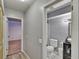 Hallway view into the bathroom featuring a toilet, vanity, and shower area at 1716 Bayou Cir, Lakeland, FL 33803