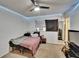 Modest bedroom with a ceiling fan, window, and minimal furniture creates a simple, functional space at 1716 Bayou Cir, Lakeland, FL 33803