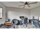 Bedroom with a ceiling fan, light gray walls, wood-look flooring, and modern desk setup at 1716 Bayou Cir, Lakeland, FL 33803