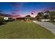 Traditional-style home with a large front yard, two-car garage, RV, and American flag displayed at 1716 Bayou Cir, Lakeland, FL 33803