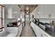 Galley kitchen featuring white cabinets, stainless steel appliances, and granite countertops at 1716 Bayou Cir, Lakeland, FL 33803
