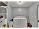 Functional laundry room with a washer and dryer and minimal decor, focusing on utility at 1716 Bayou Cir, Lakeland, FL 33803
