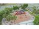 Aerial view of a playground with a train themed play structure next to tennis courts at 1716 Bayou Cir, Lakeland, FL 33803