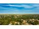 Aerial view of a residential neighborhood surrounded by lush trees under a clear blue sky at 2418 Se 23Rd St, Ocala, FL 34471