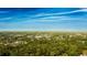 An overhead shot capturing a community nestled among dense trees with a beautiful blue sky at 2418 Se 23Rd St, Ocala, FL 34471