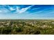 Expansive aerial view of a lush, green community under a vibrant blue sky at 2418 Se 23Rd St, Ocala, FL 34471