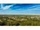 Expansive aerial view of a residential neighborhood surrounded by lush trees under a clear blue sky at 2418 Se 23Rd St, Ocala, FL 34471
