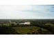 Scenic aerial view of community buildings surrounded by trees and residential neighborhoods in the distance at 2418 Se 23Rd St, Ocala, FL 34471