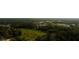 Wide aerial view of a residential neighborhood with community buildings nestled among lush green trees at 2418 Se 23Rd St, Ocala, FL 34471
