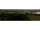 Aerial view of a neighborhood with commercial buildings and a roadway surrounded by a forest of trees at 2418 Se 23Rd St, Ocala, FL 34471