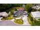 Beautiful aerial view showcasing a home with a circular driveway, mature landscaping, and a well-manicured lawn at 2418 Se 23Rd St, Ocala, FL 34471