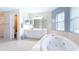 Spacious bathroom featuring a large soaking tub, dual vanity, and separate shower at 2418 Se 23Rd St, Ocala, FL 34471