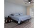 Cozy bedroom with a ceiling fan, large window, and wood-look flooring at 2418 Se 23Rd St, Ocala, FL 34471