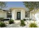 Beautiful front entrance features an elegant door with large columns and lush landscaping at 2418 Se 23Rd St, Ocala, FL 34471