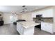 Stylish kitchen with white cabinets, granite counters, stainless appliances, and seamless access to living area at 2418 Se 23Rd St, Ocala, FL 34471