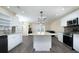 Open-concept kitchen featuring white cabinets, granite counters, stainless appliances, and an island at 2418 Se 23Rd St, Ocala, FL 34471