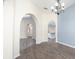 Light-filled living area featuring stylish arches and seamless transitions to other living spaces at 2418 Se 23Rd St, Ocala, FL 34471