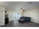 Inviting living room with wood floors, ceiling fan, and doors to the backyard at 2418 Se 23Rd St, Ocala, FL 34471