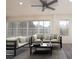 Bright living room with a ceiling fan, large windows, and comfortable seating at 2418 Se 23Rd St, Ocala, FL 34471