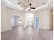 Bright living room with tray ceiling, ceiling fan, and arched doorways showcasing the home's open layout at 2418 Se 23Rd St, Ocala, FL 34471