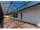 Spacious screened-in patio with brick flooring and a white exterior at 2418 Se 23Rd St, Ocala, FL 34471