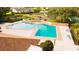 Aerial shot of the community pool area with lounge chairs and landscaped surroundings at 2418 Se 23Rd St, Ocala, FL 34471