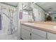 Bright bathroom featuring a vanity and a walk-in shower with floral curtains at 4846 Colonnades Club Blvd, Lakeland, FL 33811