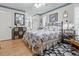 Comfortable bedroom with floral comforter, ceiling fan, and view of the bathroom at 4846 Colonnades Club Blvd, Lakeland, FL 33811