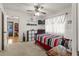 Bright bedroom features a ceiling fan, TV, and a view into a storage room at 4846 Colonnades Club Blvd, Lakeland, FL 33811