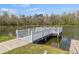 Picturesque community dock extending over a tranquil lake, offering serene waterfront views at 4846 Colonnades Club Blvd, Lakeland, FL 33811
