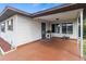 Covered outdoor area with painted flooring, offering a cozy spot with a view of the surrounding neighborhood at 4846 Colonnades Club Blvd, Lakeland, FL 33811