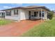 Well-kept single-story home showing a painted driveway, low-maintenance yard, and covered entryway at 4846 Colonnades Club Blvd, Lakeland, FL 33811