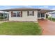 Charming single-story home featuring a well-maintained lawn and neutral siding with complementary brown shutters at 4846 Colonnades Club Blvd, Lakeland, FL 33811