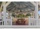 Relax at the community gazebo featuring a ceiling fan and a wooden picnic table and benches at 4846 Colonnades Club Blvd, Lakeland, FL 33811
