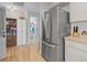 Kitchen featuring stainless steel refrigerator and nearby pantry storage, providing efficiency and organization at 4846 Colonnades Club Blvd, Lakeland, FL 33811
