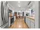 Bright, galley-style kitchen features stainless steel appliances and ample cabinet space, flowing into the dining area at 4846 Colonnades Club Blvd, Lakeland, FL 33811