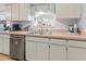 Clean kitchen featuring a double stainless steel sink with modern faucet and ample counter space at 4846 Colonnades Club Blvd, Lakeland, FL 33811