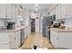 Functional galley kitchen with wood laminate flooring, stainless appliances, and plentiful storage at 4846 Colonnades Club Blvd, Lakeland, FL 33811